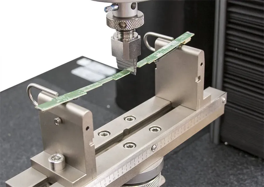 A flexible circuit board undergoing a bending test.