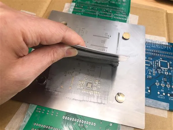 A close-up of a PCB stencil with precise openings.