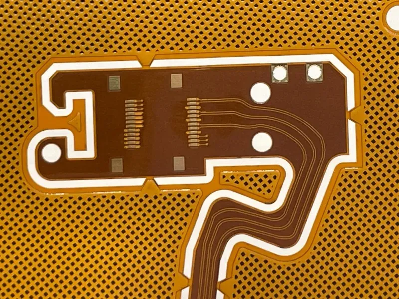 A stack of different types of FPC boards representing various cost levels.
