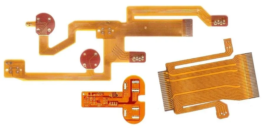 Various raw materials used in the manufacturing of flexible printed circuit boards laid out.