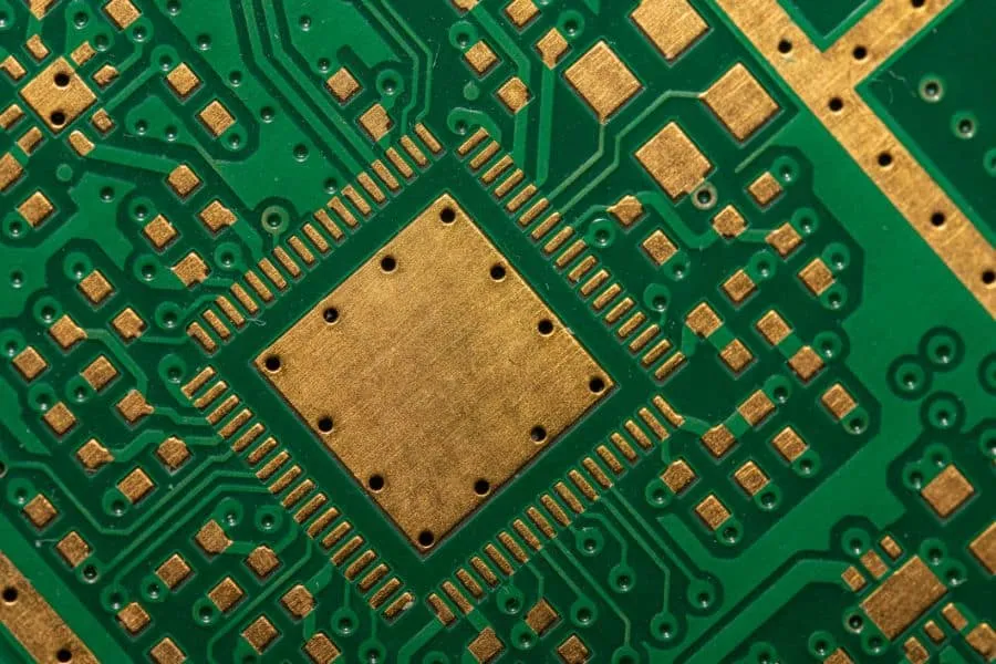 A close-up of a blank PCB board with visible copper traces.