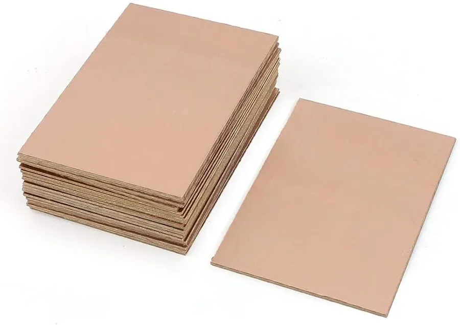 A stack of FR4 material blank PCB boards.