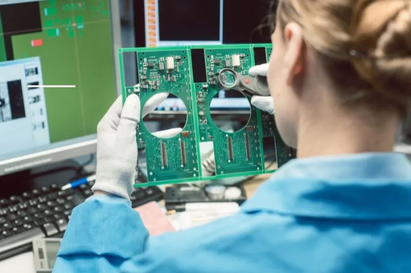 A close-up of a PCB under inspection for quality control.