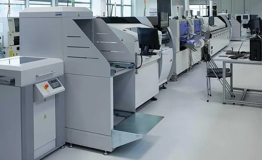 An industrial PCB assembly production line with machinery and components.
