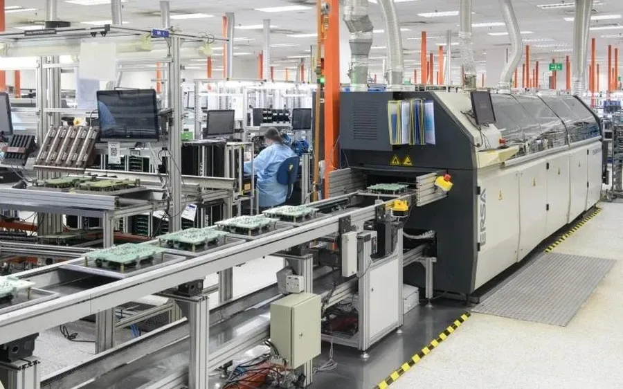 Workers assembling PCBs in a workshop.