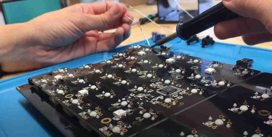 Close-up view of solder joints on a keyboard PCB.