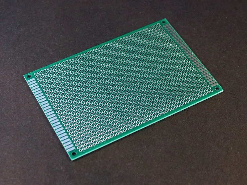 A close up of a PCB prototype board with various components.