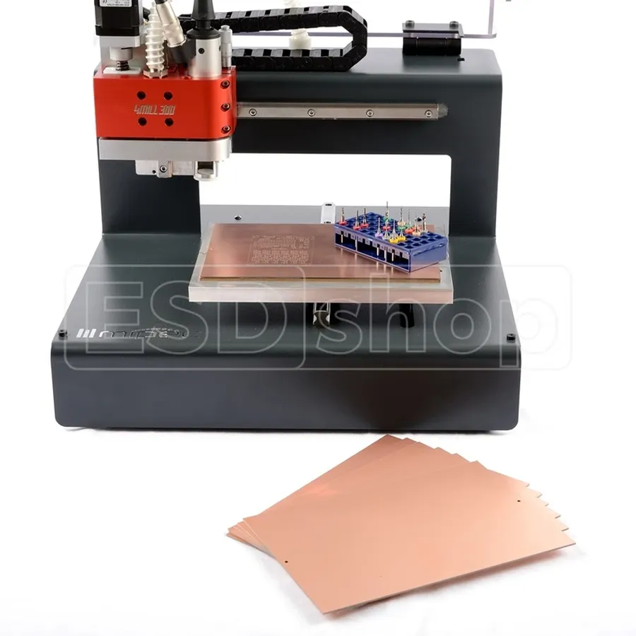 A PCB milling machine cutting a circuit board.