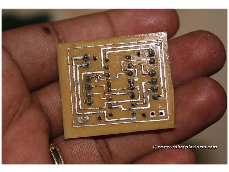 A PCB being etched in a chemical solution.