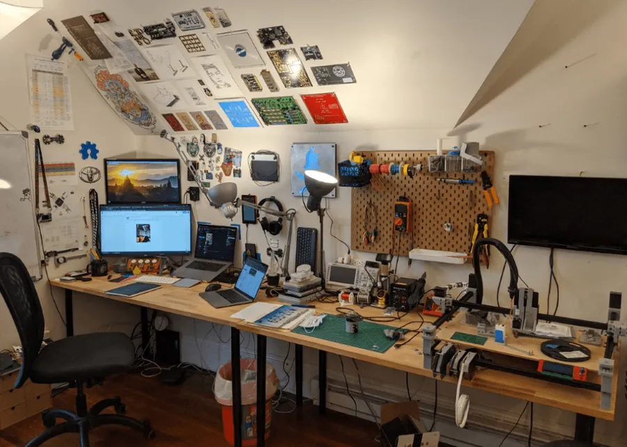 An electronics engineer's workstation with various tools and equipment.