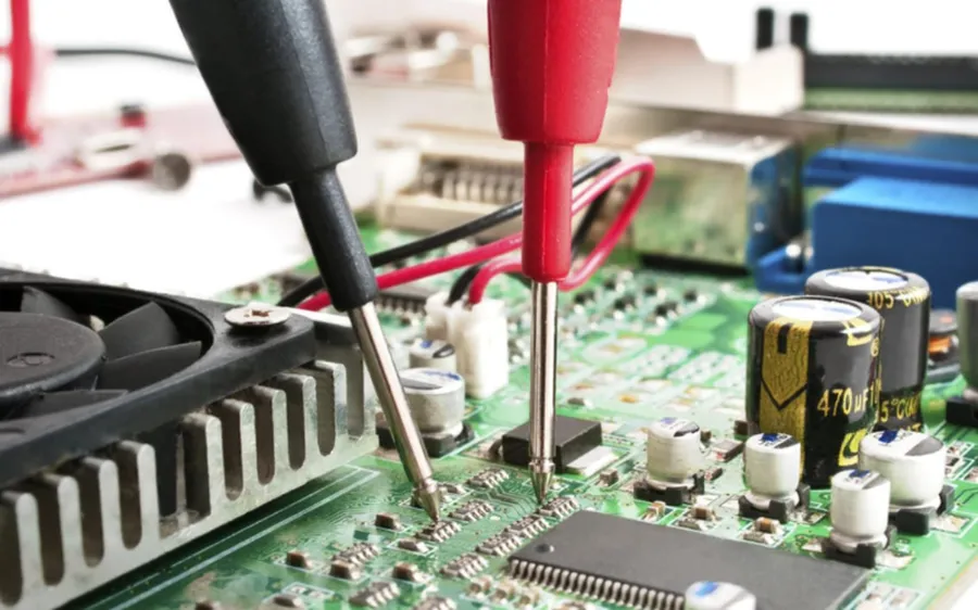 A PCB undergoing a reliability test in a testing chamber.
