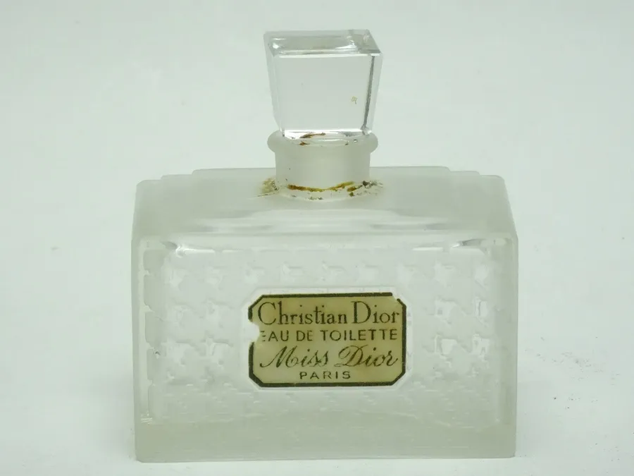 A close-up of a Miss Dior perfume bottle with its classic bow.