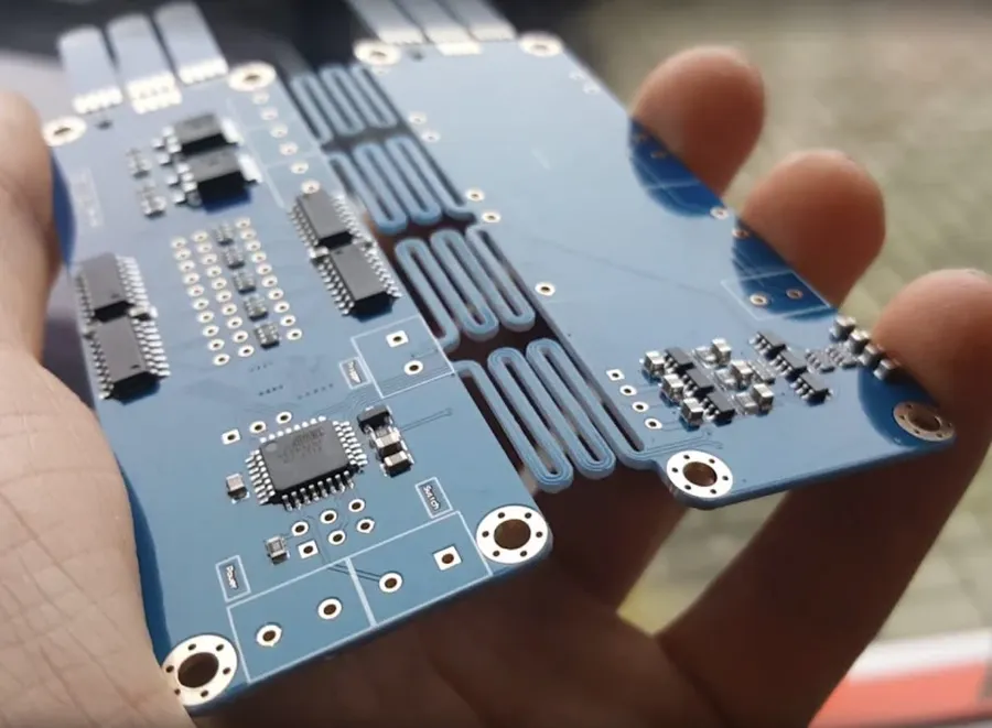 A flexible printed circuit board bent to show its flexibility.