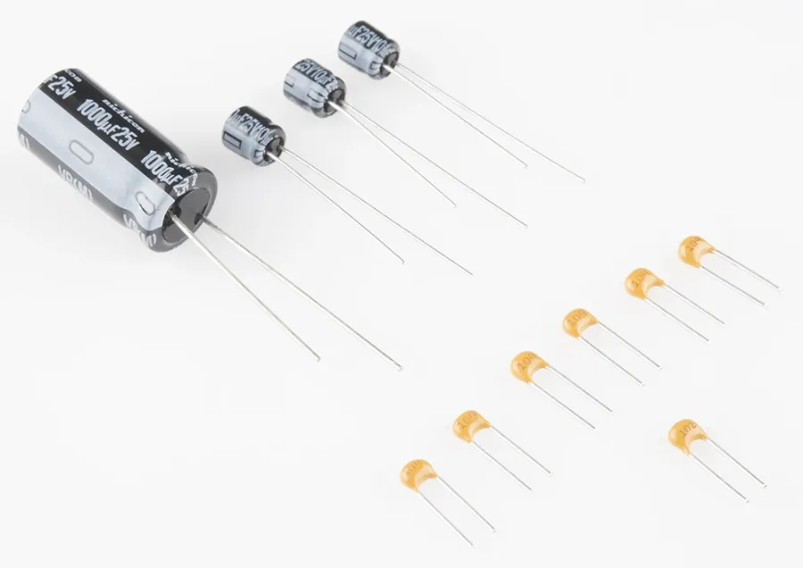 A comparison image showing different types of capacitors including ceramic and electrolytic types.