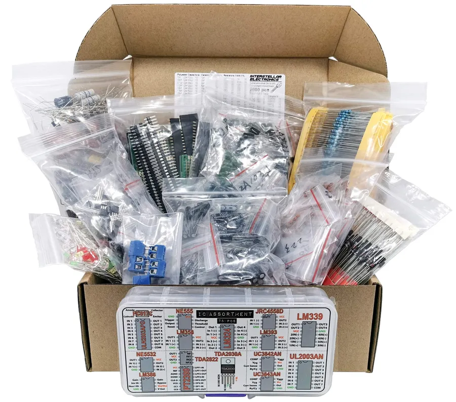 A variety of electronic components including resistors, capacitors, and ICs laid out on a table.