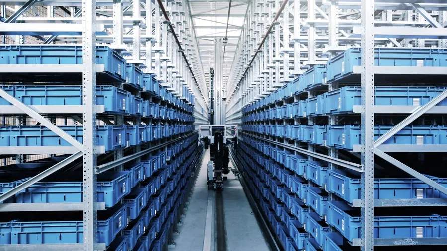 An automated warehouse facility with robots handling electronic components.