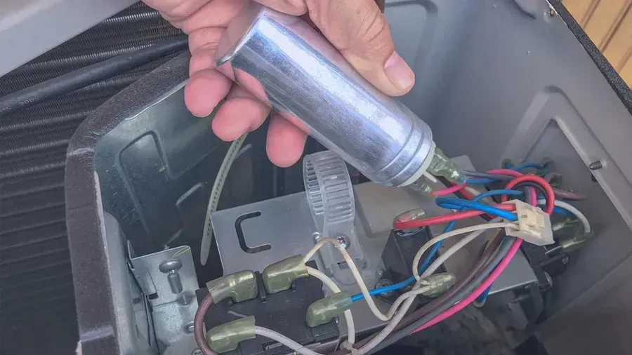 A photograph showing a bulging capacitor, a sign of failure.