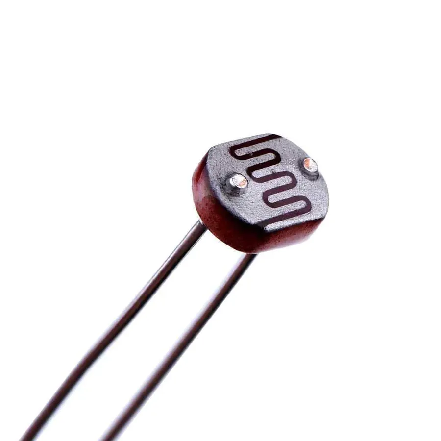 A photoresistor with visible light shining on it.