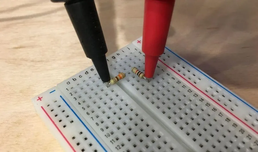 A 1k ohm resistor inserted into a breadboard.