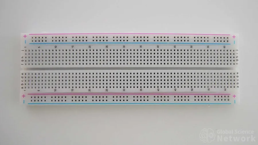 A breadboard with a 100k resistor integrated into a simple circuit.