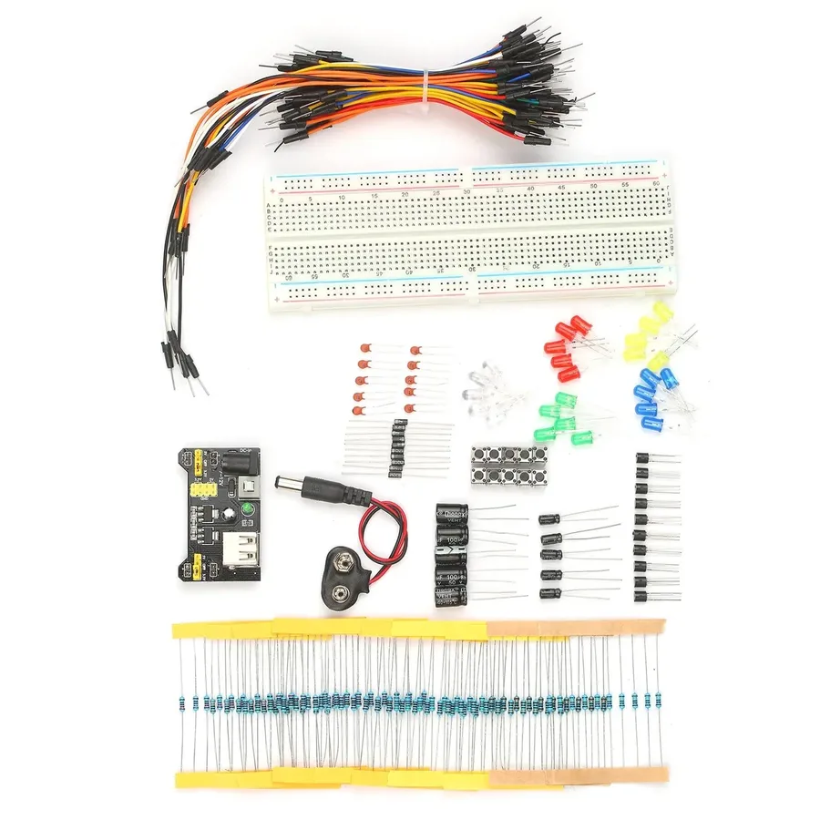 Various electronic components like resistors, capacitors, and jumper wires laid out on a breadboard.