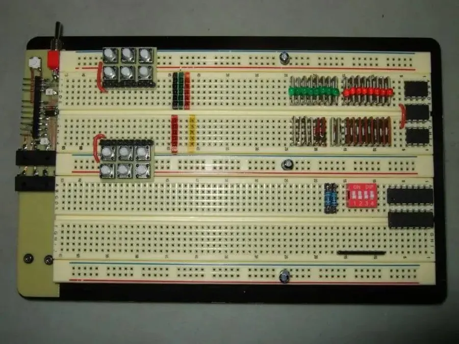 A side-by-side comparison of a breadboard and a printed circuit board.