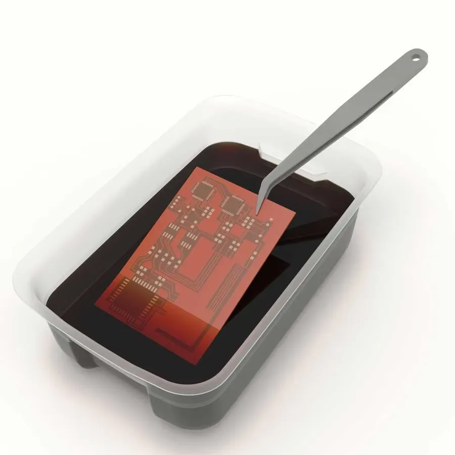 A photo showing the process of PCB etching with chemicals.