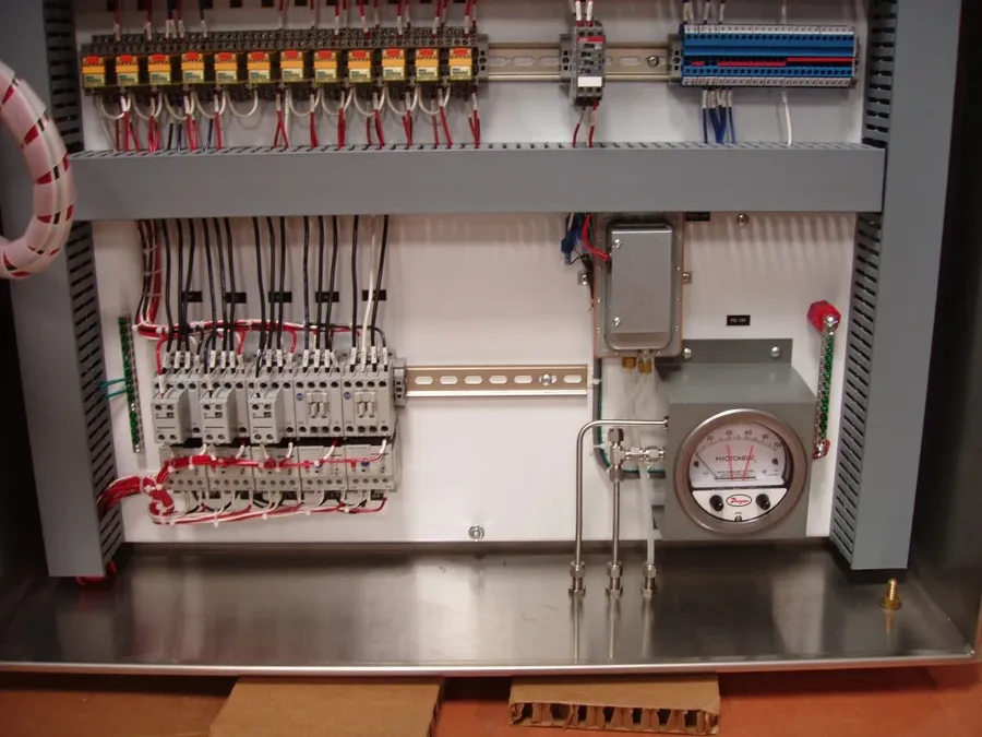 A large industrial electrical control panel with various components.