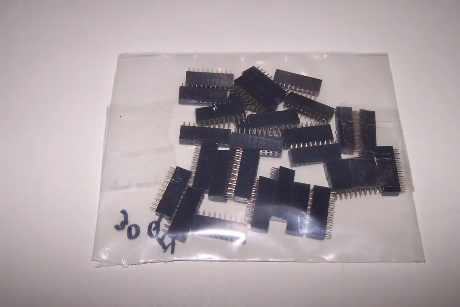 A container filled with various electronic components.