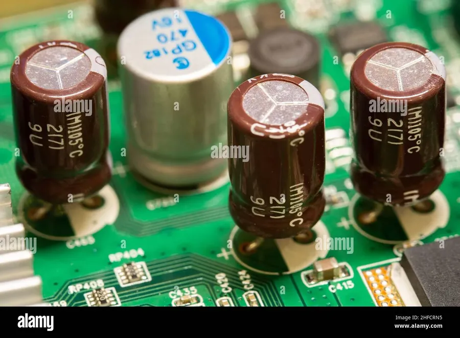 Electrolytic capacitors soldered onto a circuit board in an electronic device.