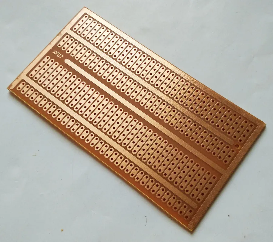 A comparison view of stripboard, perfboard, and breadboard.