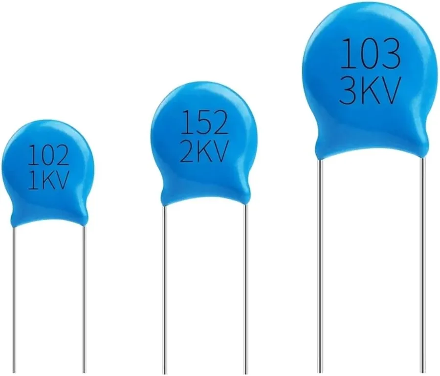 A 103 capacitor next to a ruler or scale to show its physical size.