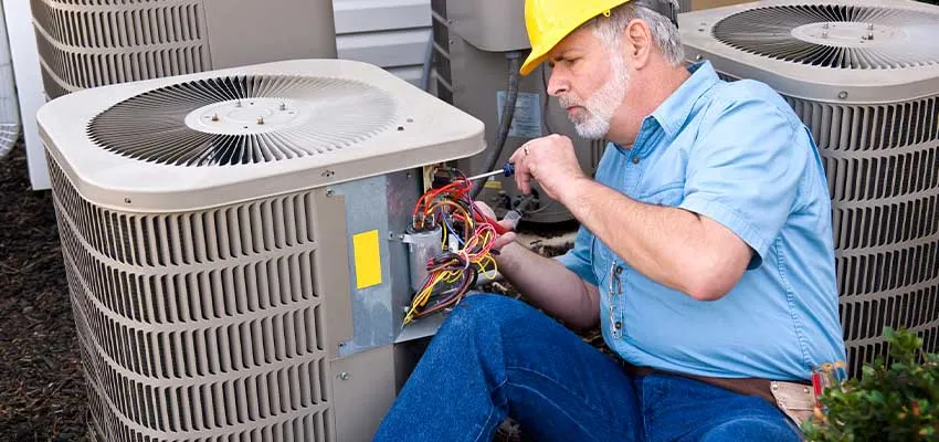 A technician repairing an air conditioner PCB board.