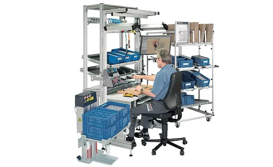 An operator working at an electronics assembly station, assembling components.