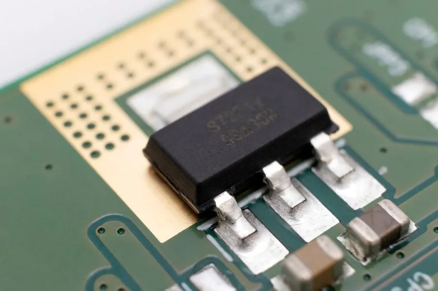 A close-up of a PCB with SMD transistors soldered on.