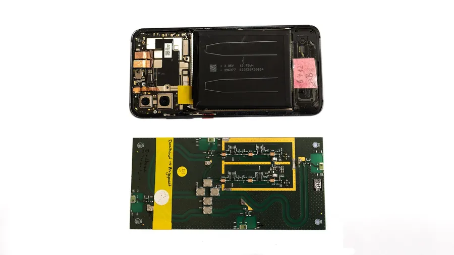 A close up view of a smartphone circuit board with ICs