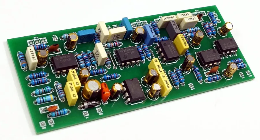 A person assembling a DIY pedal PCB.