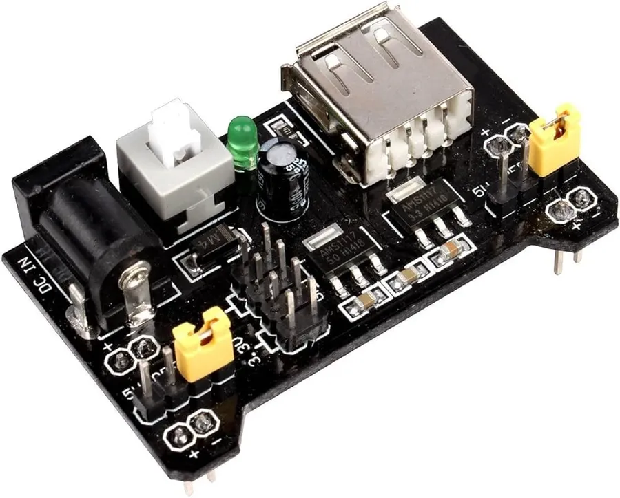 A breadboard power supply module connected to a breadboard.