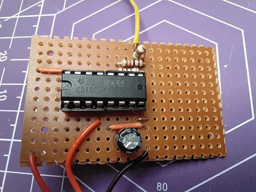 A perfboard with soldered electronic components representing a transition from a breadboard circuit.