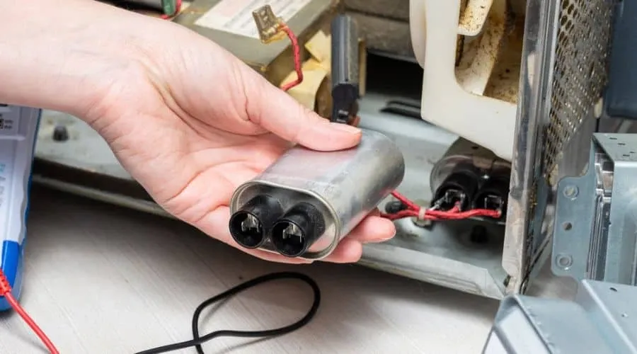 A swollen or damaged microwave capacitor.