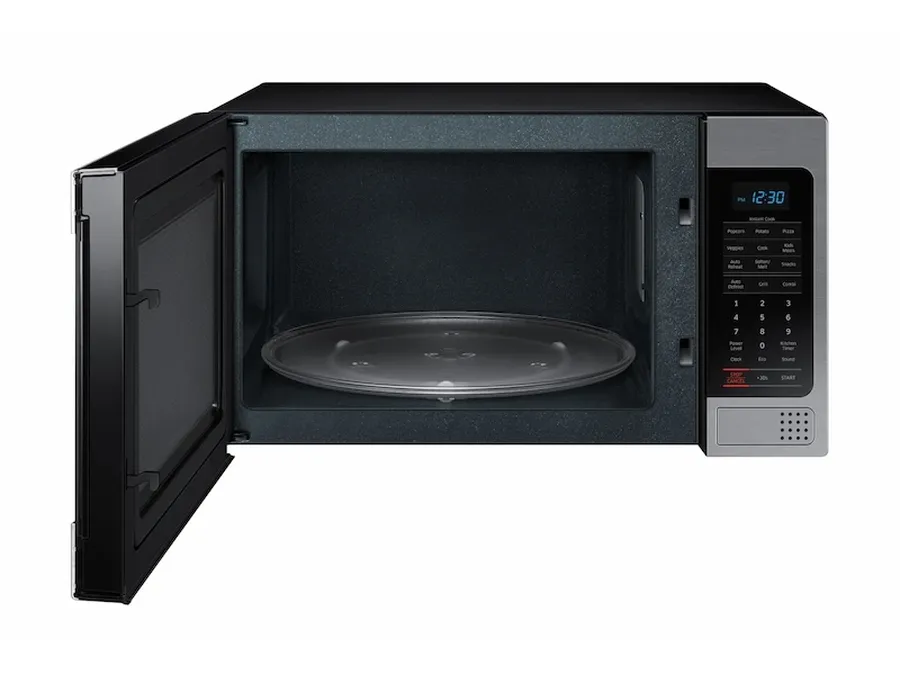 The inside of a microwave oven with the capacitor visible.