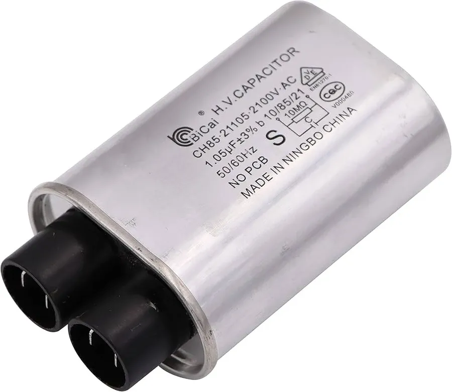 Hands replacing a microwave capacitor inside a microwave oven.