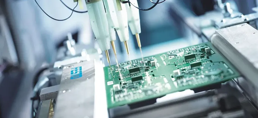 A PCB manufacturing workshop with machines and workers.