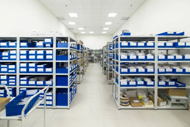 A warehouse filled with shelves of electronic components, including capacitors.