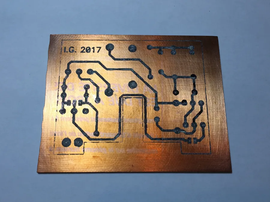 A DIY PCB being etched using a chemical solution.