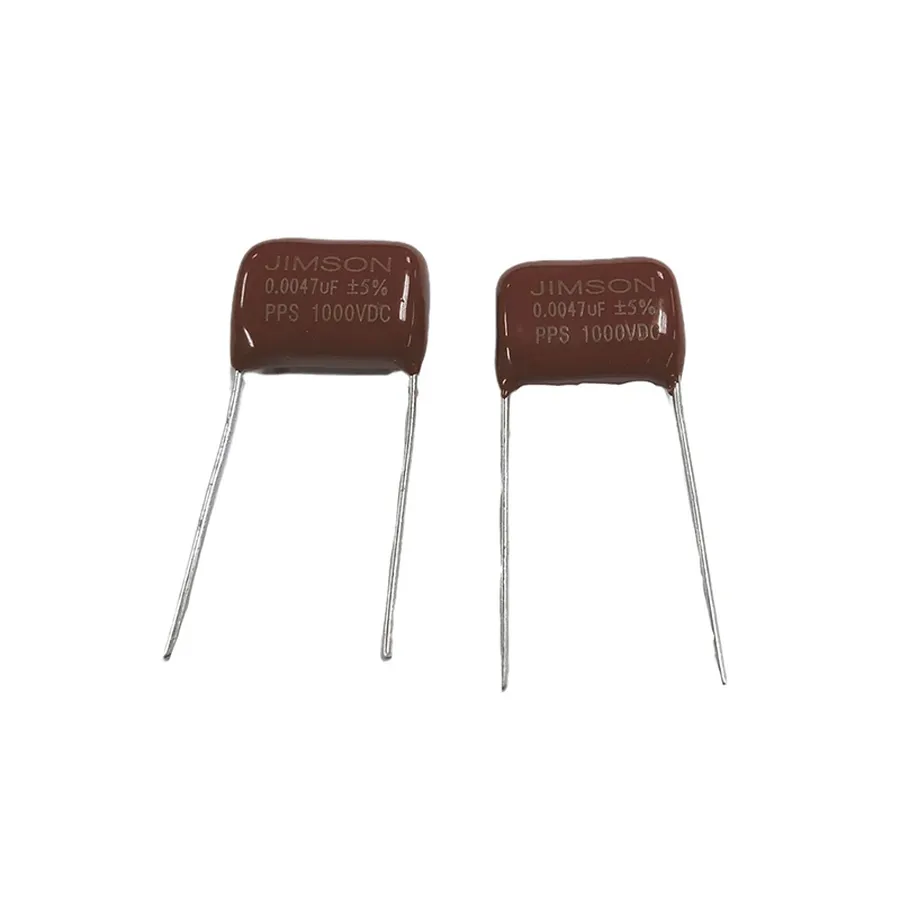 A person selecting from a range of high voltage capacitors.