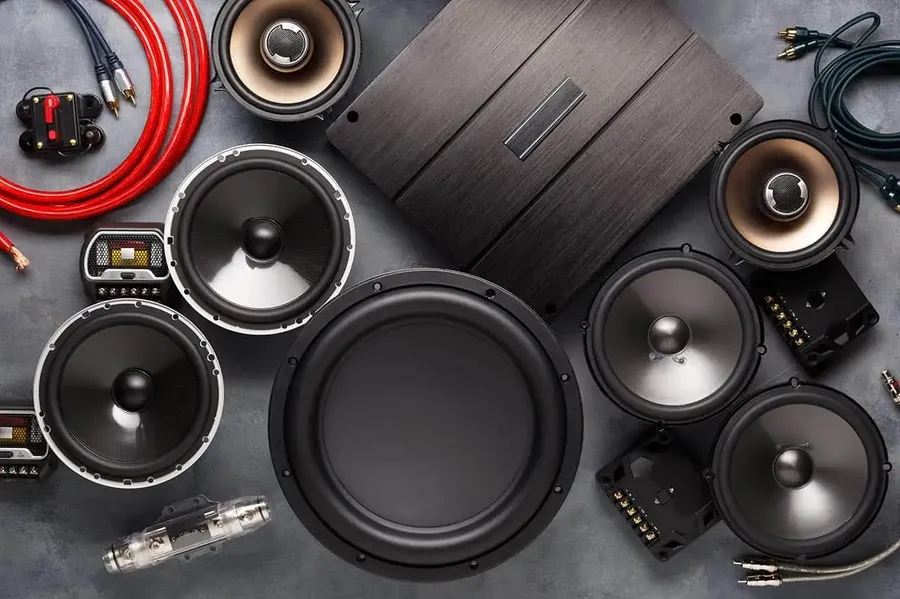 An installed car audio system, including amplifier, speakers, and wiring.