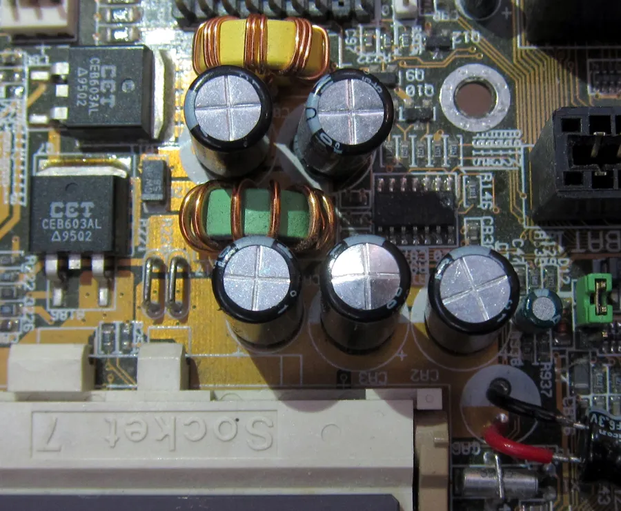 A motherboard with a visibly bulging capacitor.