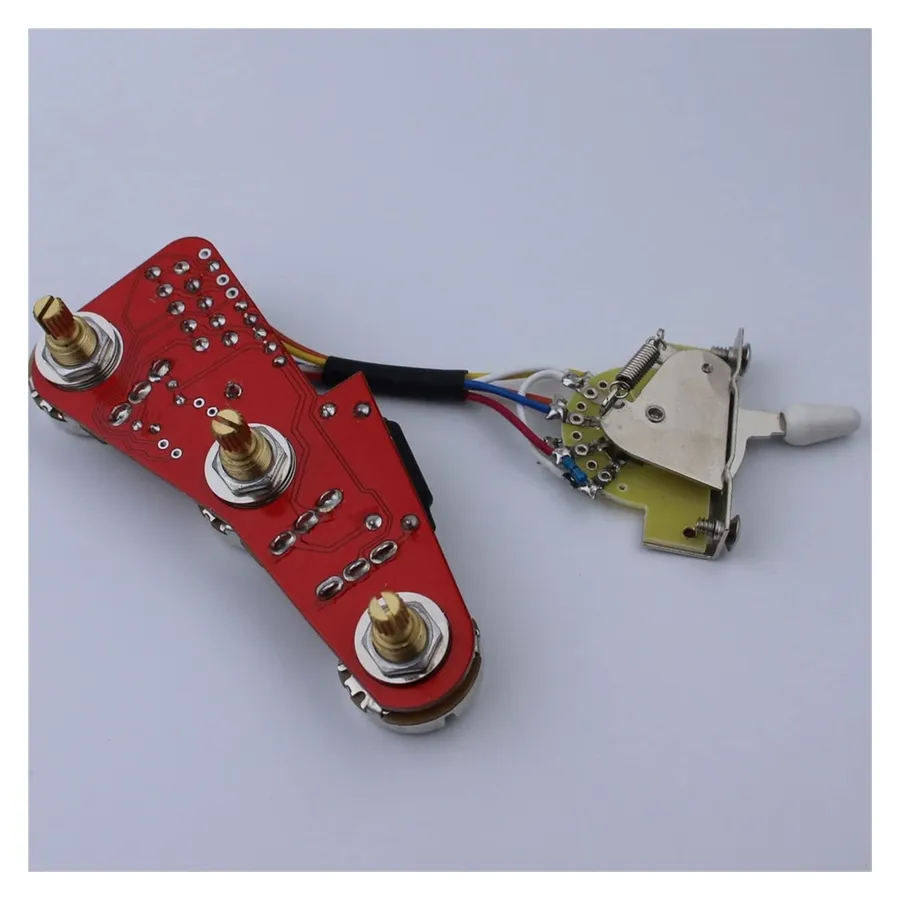 The interior wiring of a guitar with potentiometers visible