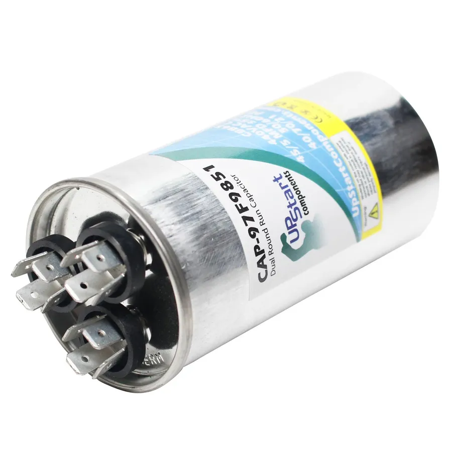 A visibly damaged dual run capacitor showing signs of failure.